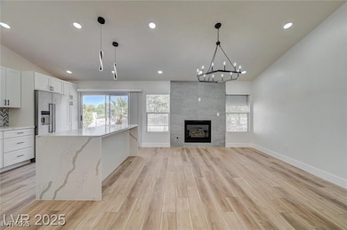 Unfurnished living room featuring lofted ceiling,