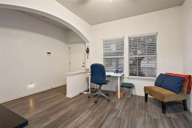 Office area with wood finished floors and arched 