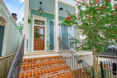Brick stairwell leads to inviting front porch
