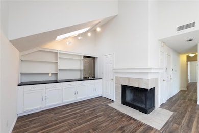 Unfurnished living room with a tiled fireplace, a 