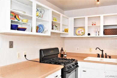 Gas Cooking, White cabinets, tile backsplash and a pantry in the kitchen