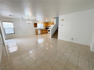 Unfurnished living room with an inviting chandelie