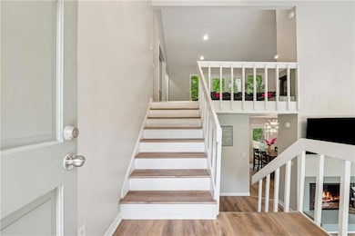Stairway featuring wood finished floors and baseboards