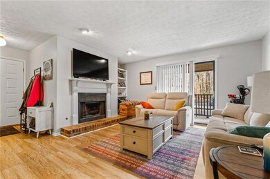 Living room featuring a fireplace, a textured ceil