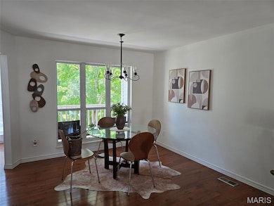Dining room featuring a chandelier and hardwood / wood-style floors