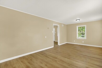 Spare room featuring crown molding and hardwood / 