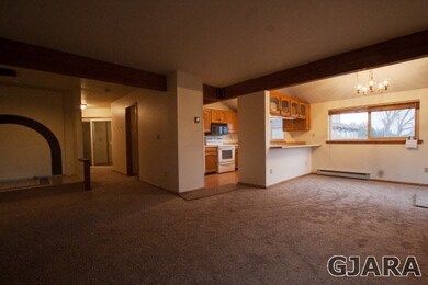 living room towards dining area & kitchen on the r
