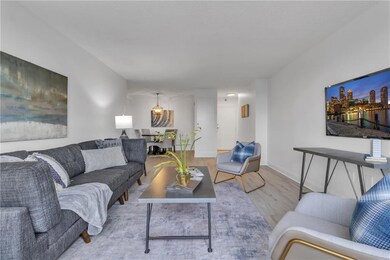 Living area with wood finished floors and baseboards