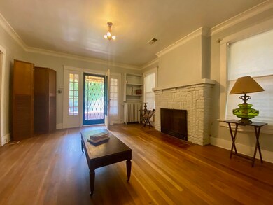Living room featuring radiator heating unit, wood-