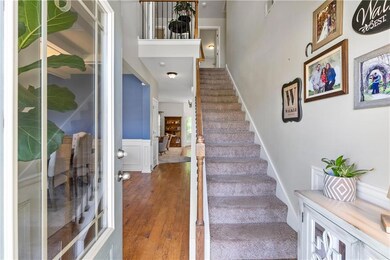 Staircase with a wainscoted wall, visible vents, a