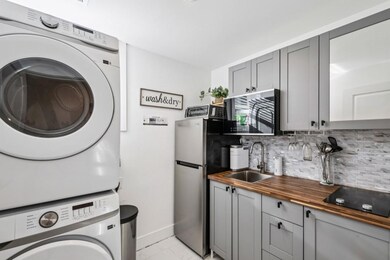 The Fully Finished Basement offers endless flexibility with Two Additional Bedrooms, a Full Bath, a Dedicated Office, Laundry Room, Den, and a Second Kitchenette ideal for Guests, Extended Family, or a potential Income-Producing Suite.