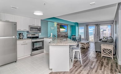 Kitchen with tasteful backsplash, white cabinetry,