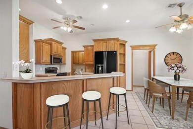 Kitchen with black appliances, ceiling fan, kitche