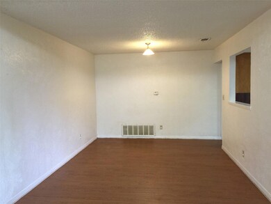 Spare room featuring dark wood-style flooring and