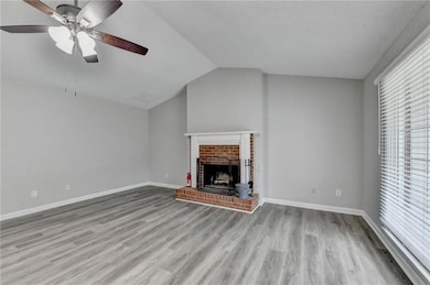 Unfurnished living room with a brick fireplace, ce