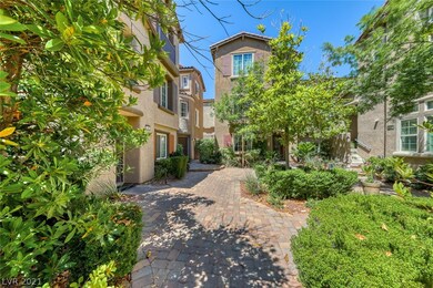 Courtyard entry with wrought iron fence, pavers an