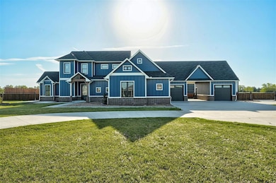 Craftsman-style home featuring roof with shingles, concrete driveway, fence, an attached garage, and board and batten siding