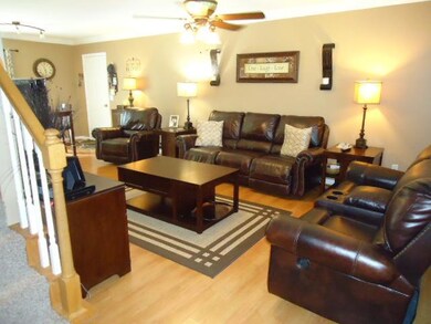 This is view of living room as you enter the home. Laminate wood flooring, new ceiling fan, fresh paint