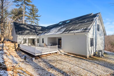 View of the back of the home showing yard space an
