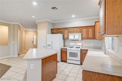 Kitchen featuring white appliances, light tile pat