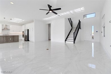 Unfurnished living room featuring ceiling fan and