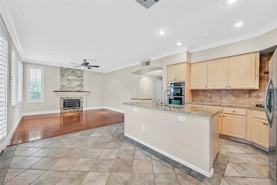 Kitchen featuring a ceiling fan, stainless steel d