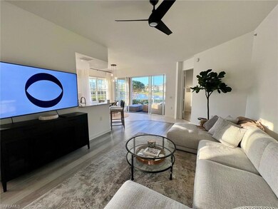 Living room with ceiling fan and light hardwood / 