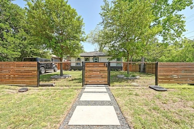View of yard featuring a gate and a fenced front 