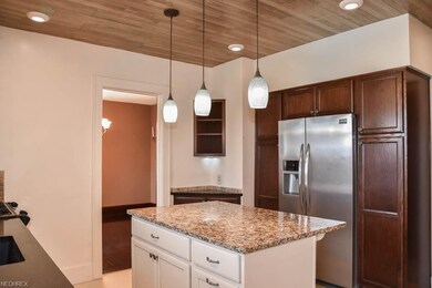 Wood plank ceiling and a center island with breakf
