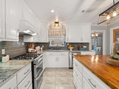 Kitchen with pendant lighting, appliances with sta