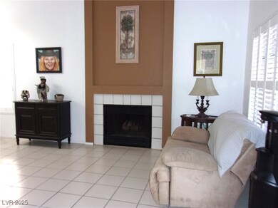 Living room with a tile fireplace and light tile p