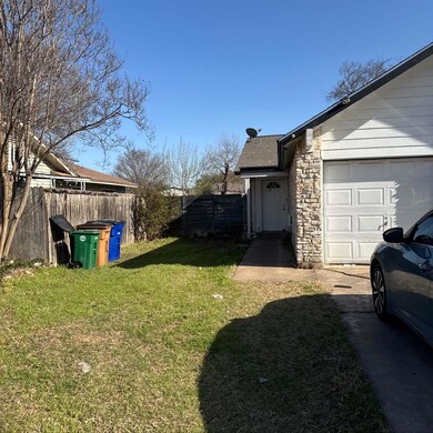 View of yard with a garage and fence