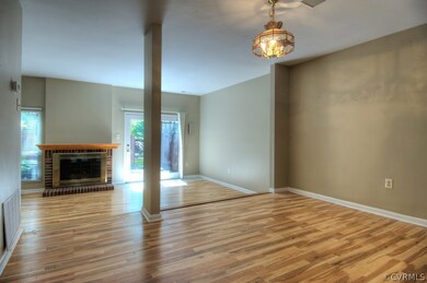 Open floor plan with gas fireplace, door to the re