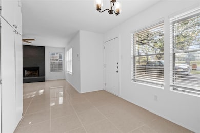 Entrance foyer with an inviting chandelier, baseb