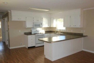 Kitchen has gas oven, lots of cabinets and food bar