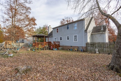Rear view of property featuring a deck and central