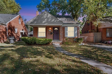 Bungalow-style house with a chimney, brick siding, and a gate