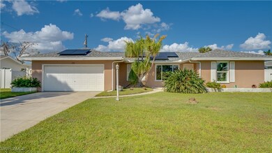 Ranch-style home featuring a garage, a front lawn,