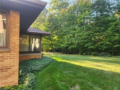View of yard and 3 season room.