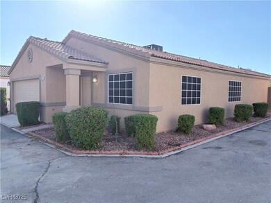 View of front of house with stucco siding and a tile roof