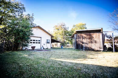 side yard with barn/shed and covered trailer parking