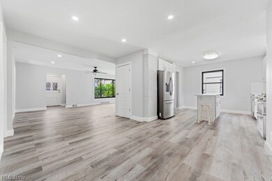 Unfurnished living room with light hardwood / wood-style floors and ceiling fan
