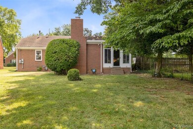 Back of house featuring a lawn