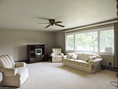 Living room has a wood burning fireplace with a st