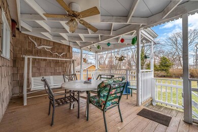 Wooden deck with outdoor dining area and a ceiling