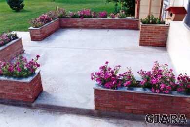 Older picture of front patio framed by planter box