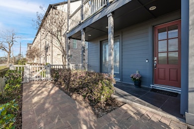 Charming townhouse entrance with a covered porch,