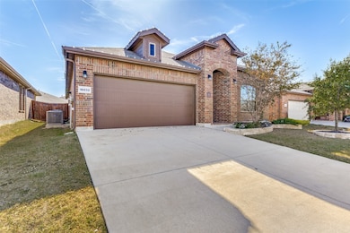 French country home featuring brick siding, driveway, and a garage