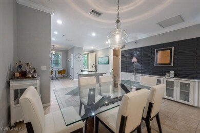 Dining area with crown molding, light tile pattern
