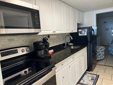 Kitchen featuring sink, decorative backsplash, app